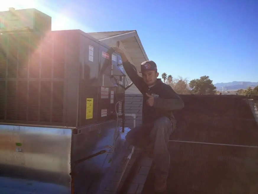 HVAC technician performing HVAC Inspection on a rooftop unit in Hibbing